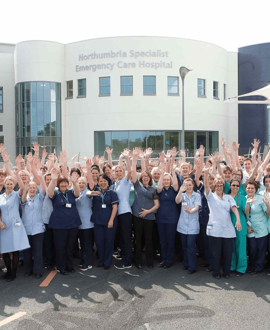 Nurses in front of Northumbria Healthcare NHS Foundation Trust